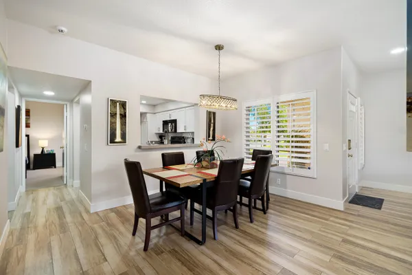 a view of a dining room with furniture window and wooden floor