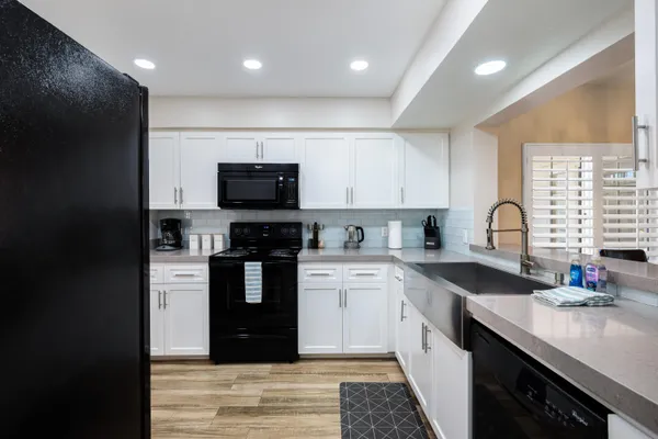 a kitchen with a sink stove and cabinets