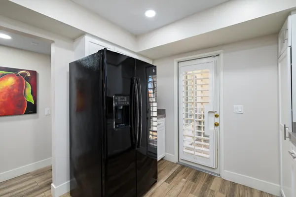a kitchen with stainless steel appliances granite countertop a stove top oven a sink dishwasher a refrigerator and a microwave