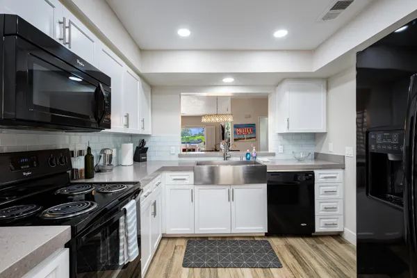 a kitchen with stainless steel appliances a refrigerator and cabinets