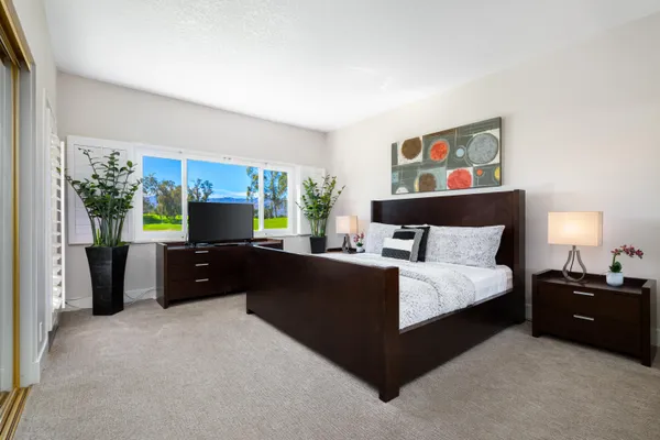 a bedroom with a bed and a couch