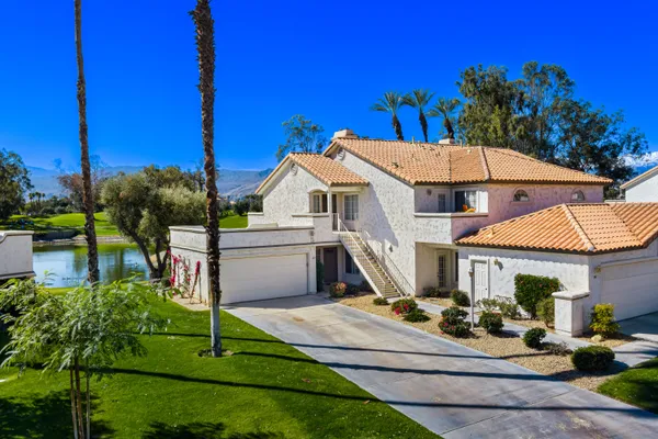 an aerial view of a house with yard swimming pool and outdoor seating