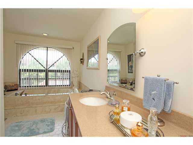 169 Southeast Wavecrest Way Boca Raton, FL 33432 - Photo 11 of 25 a bathroom with a sink mirror and a bath tub