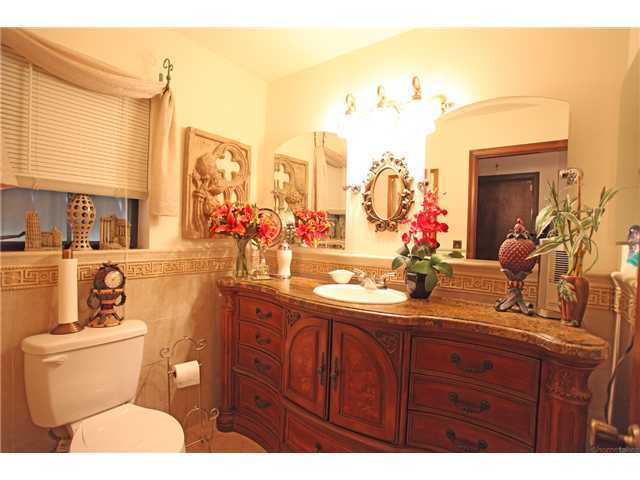 169 Southeast Wavecrest Way Boca Raton, FL 33432 - Photo 12 of 25 a bathroom with a toilet sink and mirror