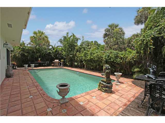169 Southeast Wavecrest Way Boca Raton, FL 33432 - Photo 2 of 25 a view of a swimming pool with a yard
