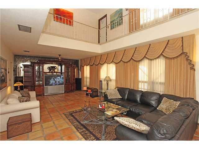 169 Southeast Wavecrest Way Boca Raton, FL 33432 - Photo 5 of 25 a living room with furniture a table and a chandelier