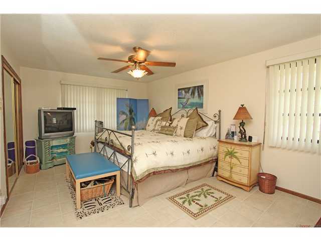 169 Southeast Wavecrest Way Boca Raton, FL 33432 - Photo 10 of 25 a bedroom with a bed a computer on the desk and a dresser