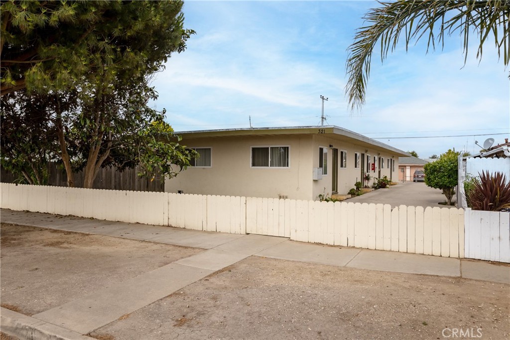 321 North K Street Lompoc, CA 93436 - Photo 1 of 32 a front view of a house with a yard and garage