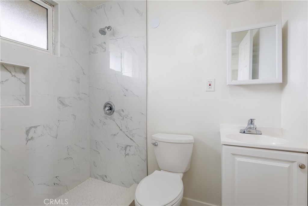 321 North K Street Lompoc, CA 93436 - Photo 11 of 32 a white toilet sitting next to a bathroom sink