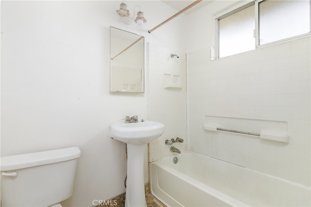 321 North K Street Lompoc, CA 93436 - Photo 16 of 32 a bathroom with a sink a toilet and shower