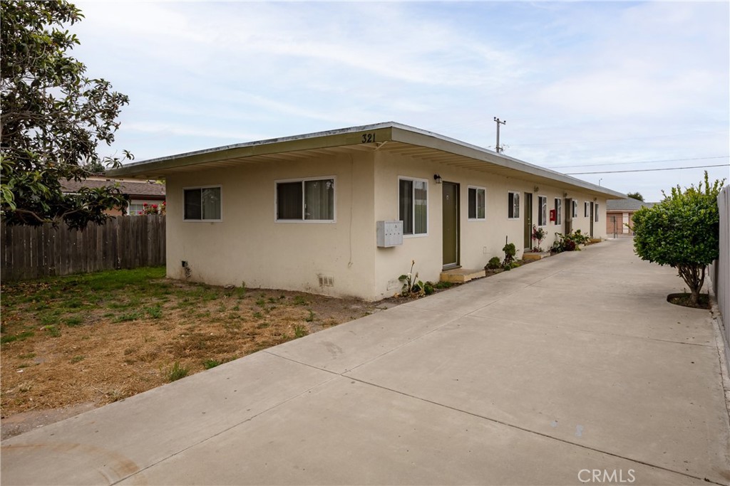 321 North K Street Lompoc, CA 93436 - Photo 2 of 32 a house with trees in the background