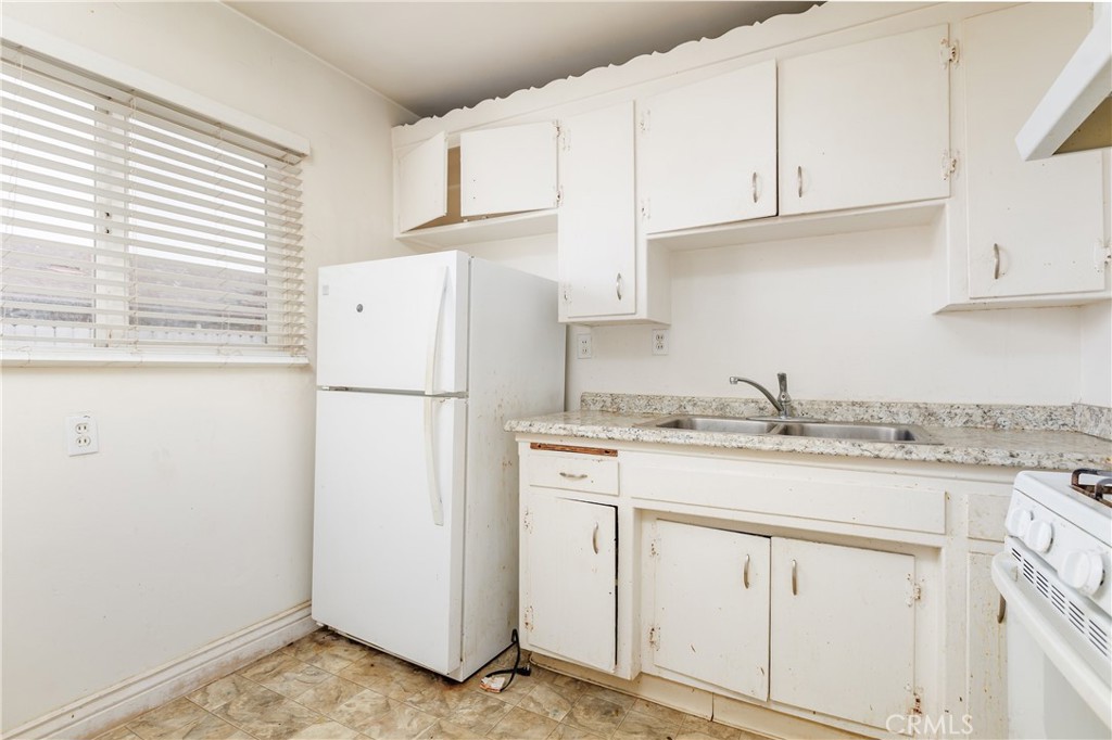 321 North K Street Lompoc, CA 93436 - Photo 24 of 32 a kitchen with appliances cabinets and a window