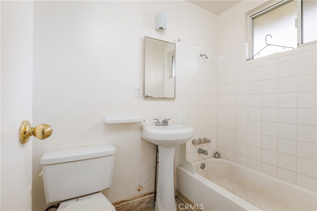 321 North K Street Lompoc, CA 93436 - Photo 26 of 32 a bathroom with a sink a toilet and shower