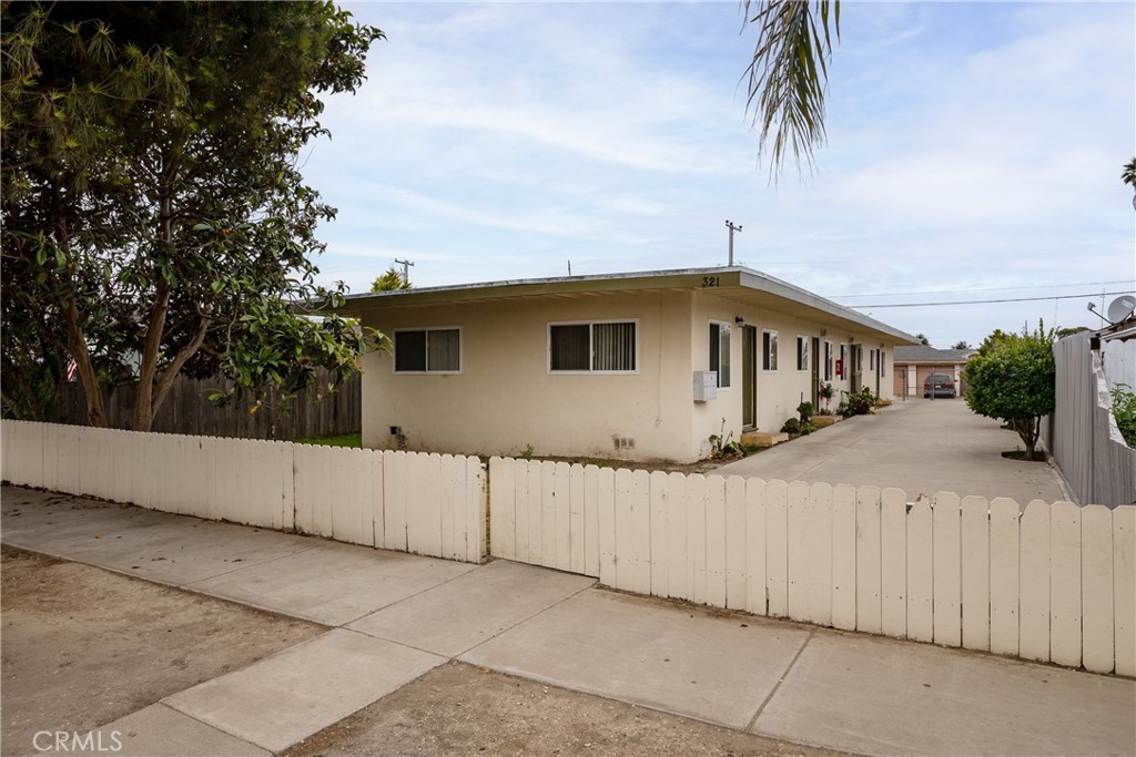 321 North K Street Lompoc, CA 93436 - Photo 31 of 32 a view of a house with a wooden fence
