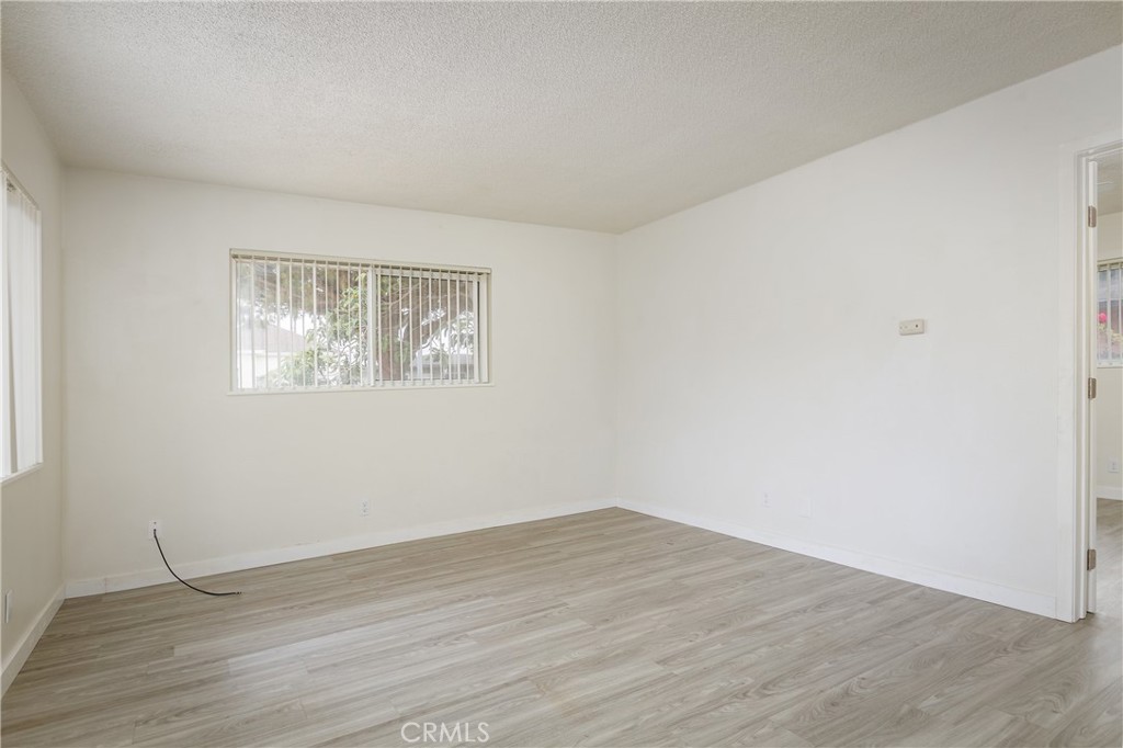 321 North K Street Lompoc, CA 93436 - Photo 7 of 32 a view of a big room with wooden floor and windows