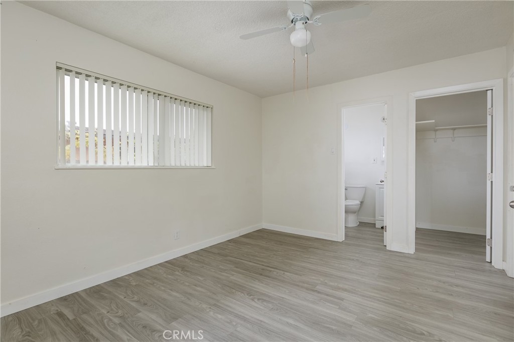321 North K Street Lompoc, CA 93436 - Photo 9 of 32 an empty room with wooden floor and windows