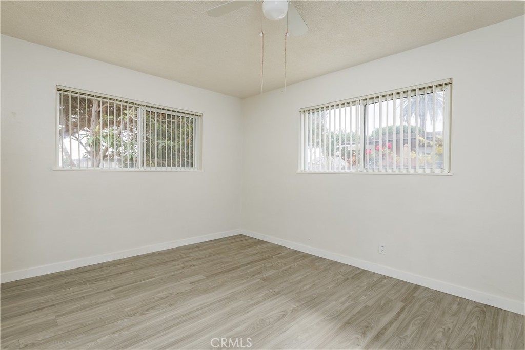 321 North K Street Lompoc, CA 93436 - Photo 10 of 32 a view of an empty room with wooden floor and a window