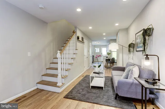 a view of entryway and hall with wooden floor