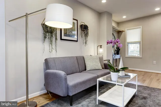 a living room with furniture and a chandelier