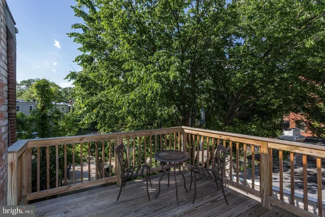 a view of balcony with deck and trees