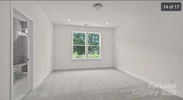 an empty room with windows and entrance
