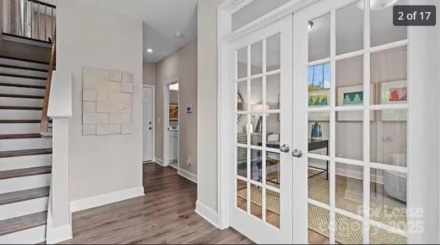 a view of entryway with wooden floor and windows