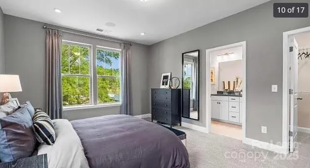 a bedroom with a bed and a large mirror