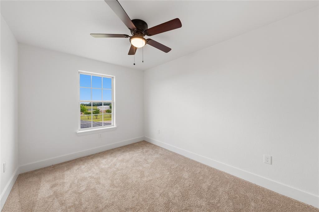 1128 Newton Road Ferris, TX 75125 - Photo 23 of 28 Neutral color palette featuring light beige carpet and white walls