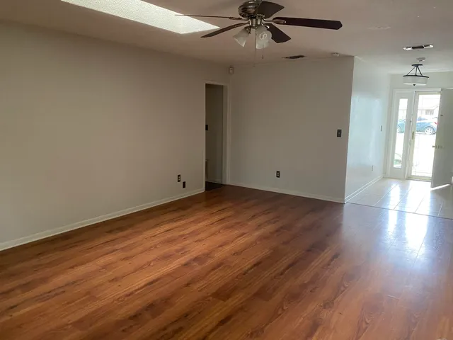 wooden floor in an empty room with a window