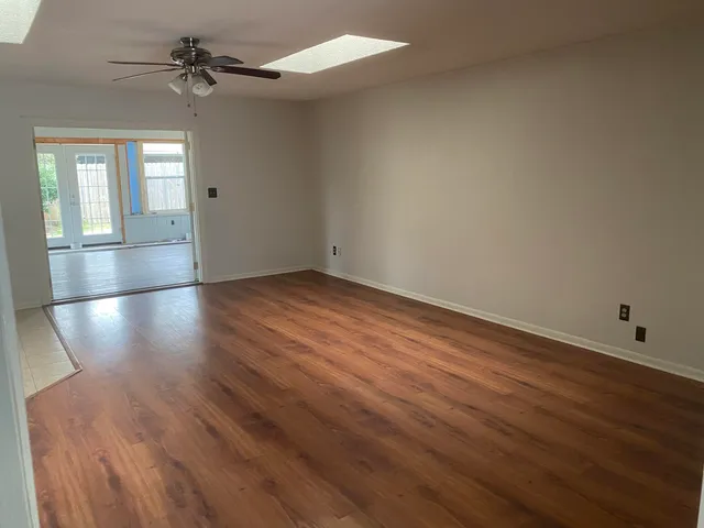 wooden floor in an empty room with a window