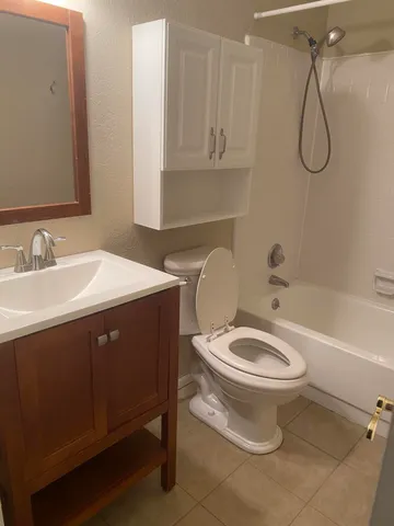 a bathroom with a sink vanity mirror and toilet