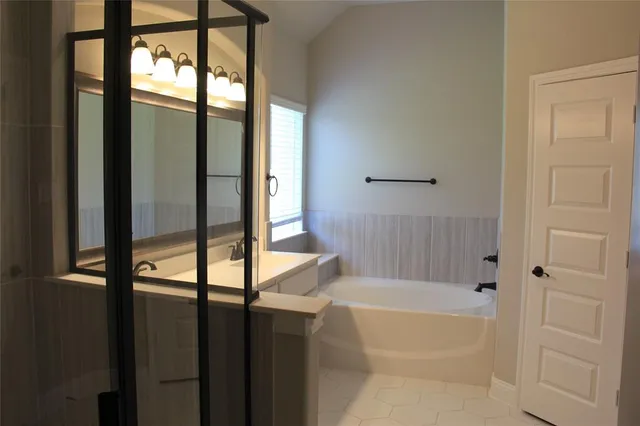 a bathroom with bathtub and a shower