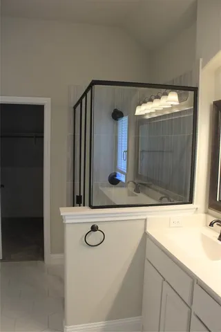 a bathroom with a sink and mirror