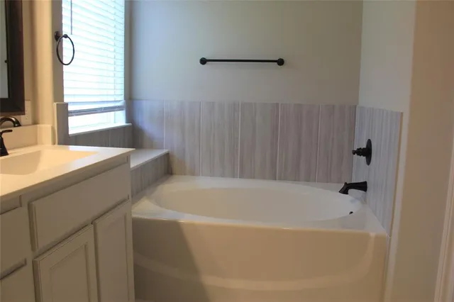 a bathroom with a sink and a bathtub
