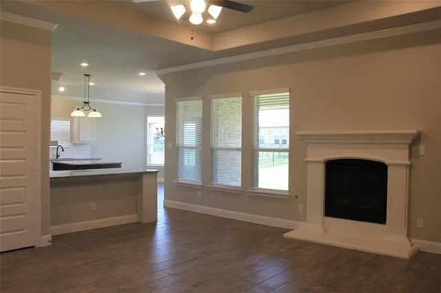 a open kitchen with a fireplace and a large window