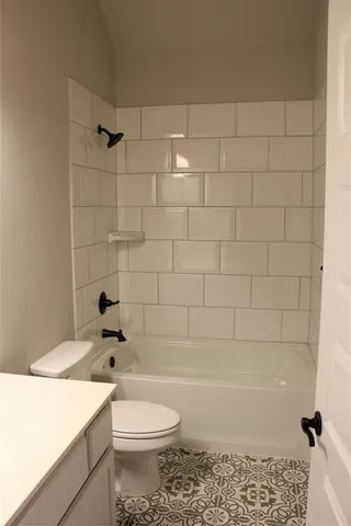 a bathroom with a toilet a sink and shower