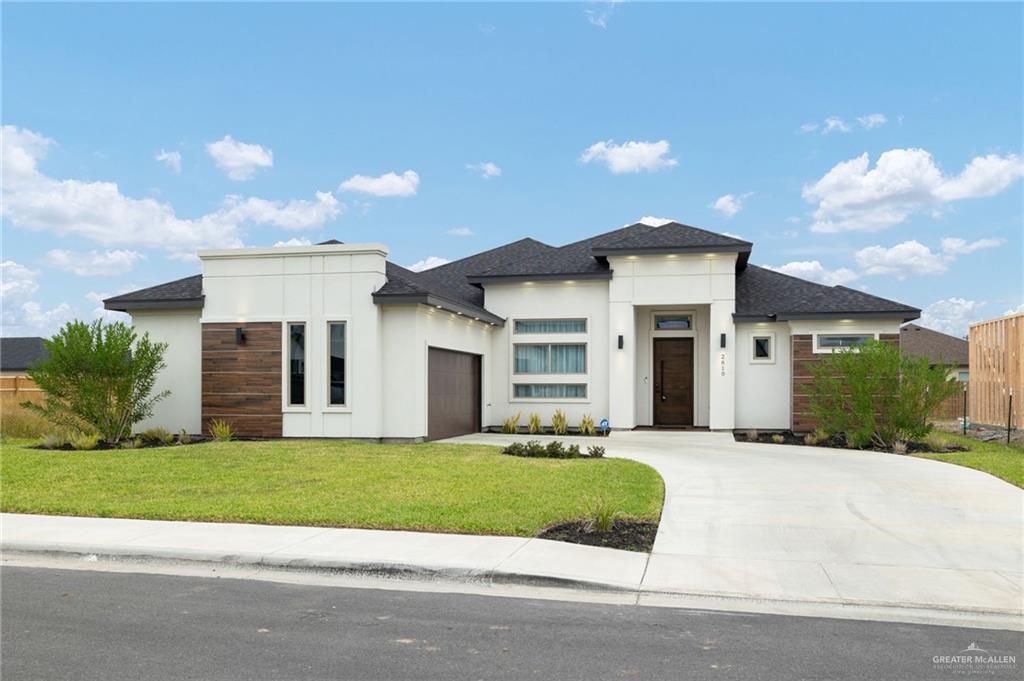 2610 East Julian Road Harlingen, TX 78552 - Photo 1 of 21 a front view of a house with a yard and garage