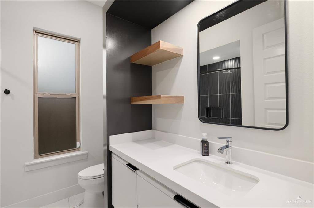 2610 East Julian Road Harlingen, TX 78552 - Photo 13 of 21 a bathroom with a sink toilet and shower