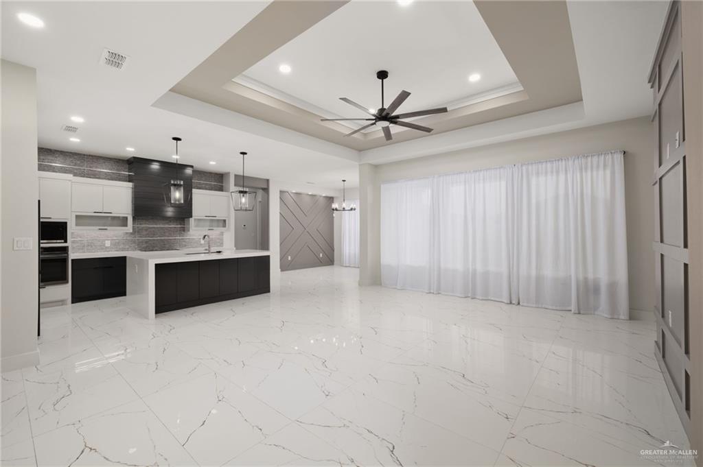 2610 East Julian Road Harlingen, TX 78552 - Photo 3 of 21 a large white kitchen with a large window stainless steel appliances