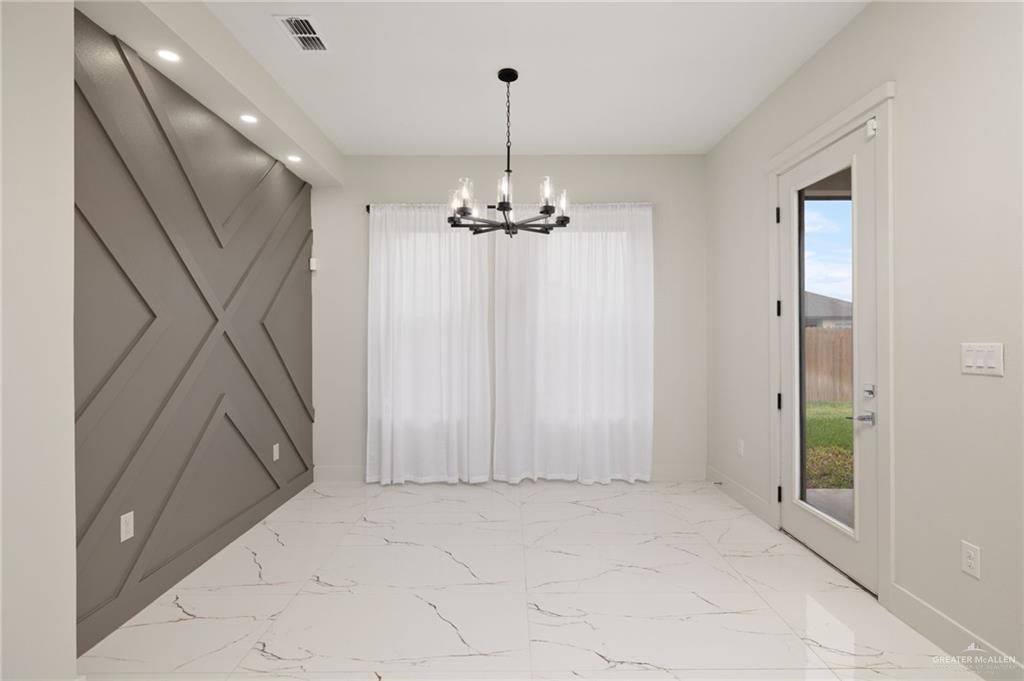 2610 East Julian Road Harlingen, TX 78552 - Photo 5 of 21 a view of a hallway with chandelier and entryway