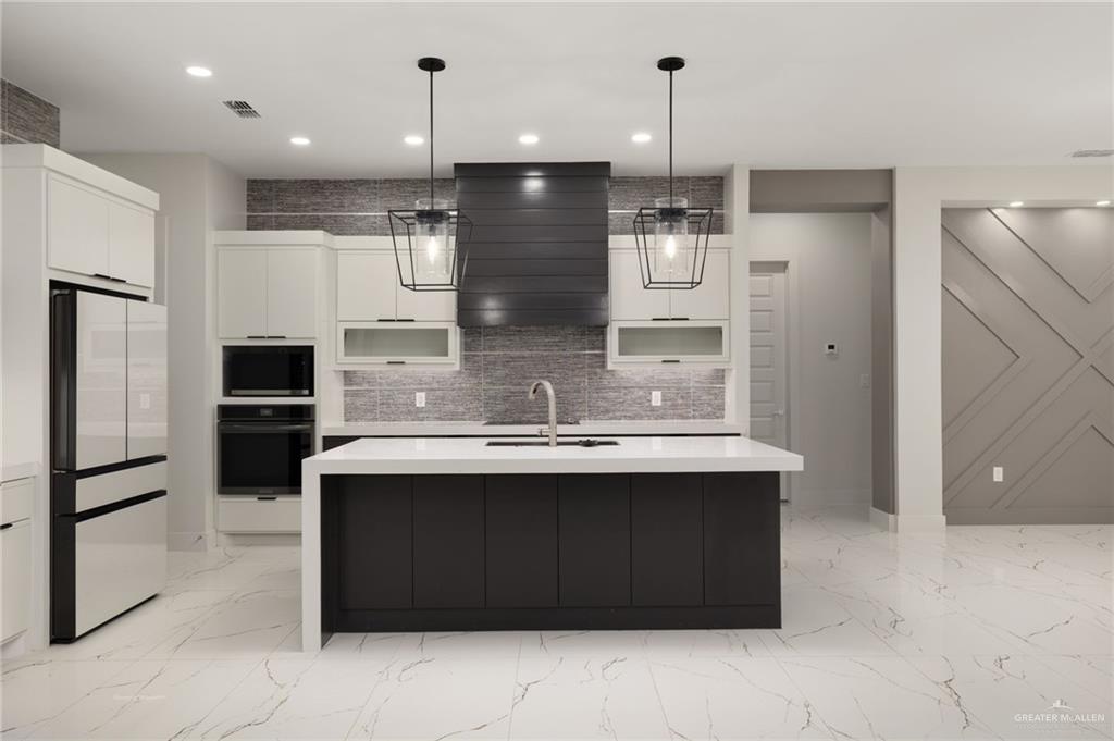 2610 East Julian Road Harlingen, TX 78552 - Photo 6 of 21 a kitchen with kitchen island a sink stainless steel appliances and cabinets