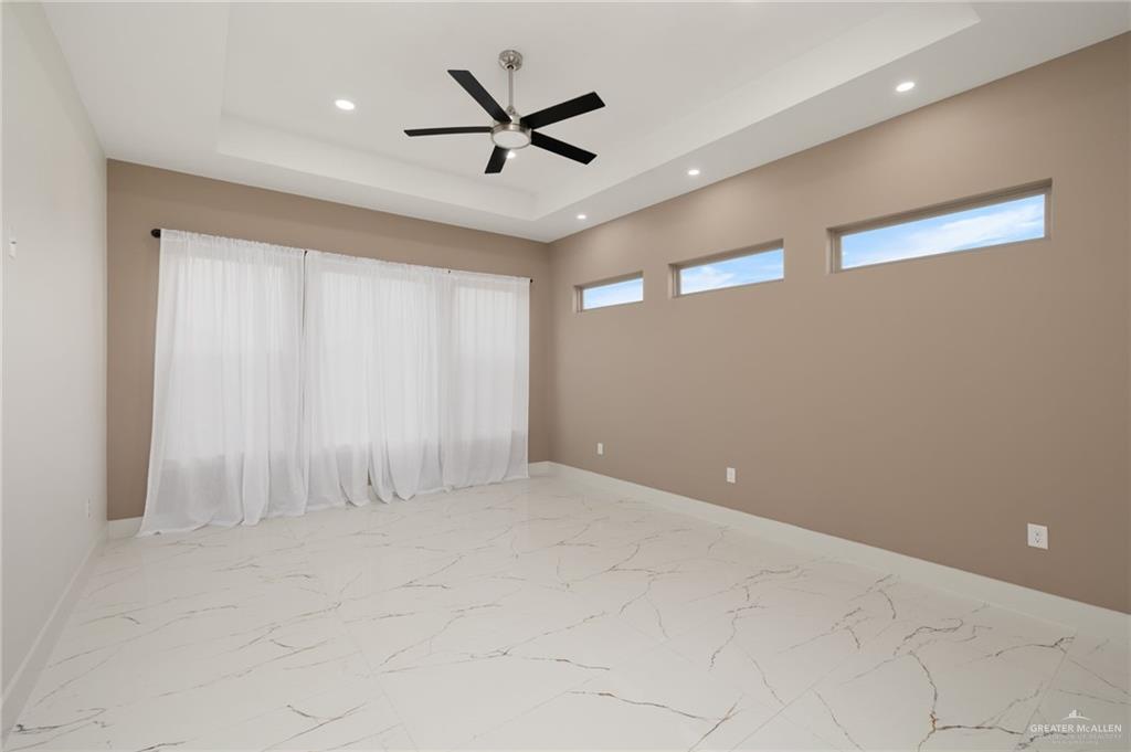 2610 East Julian Road Harlingen, TX 78552 - Photo 7 of 21 an empty room with ceiling fan and windows