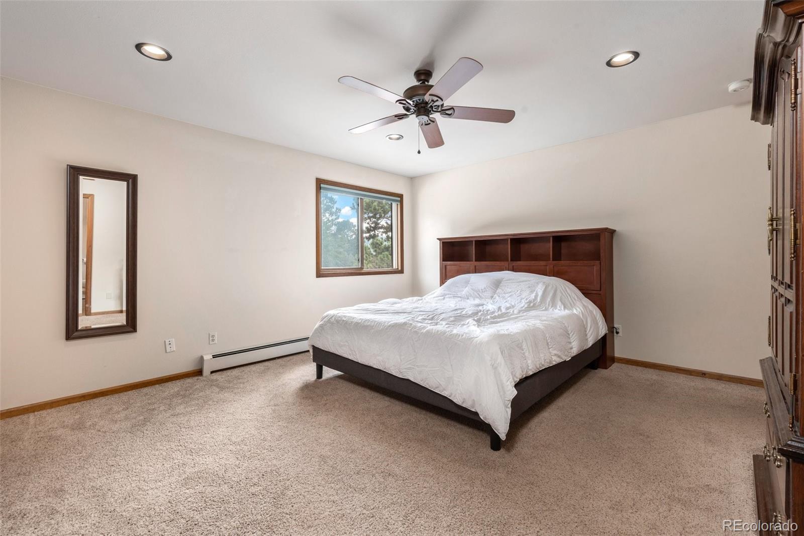 30540 Rand Road Conifer, CO 80433 - Photo 11 of 37 a bedroom with a bed and window