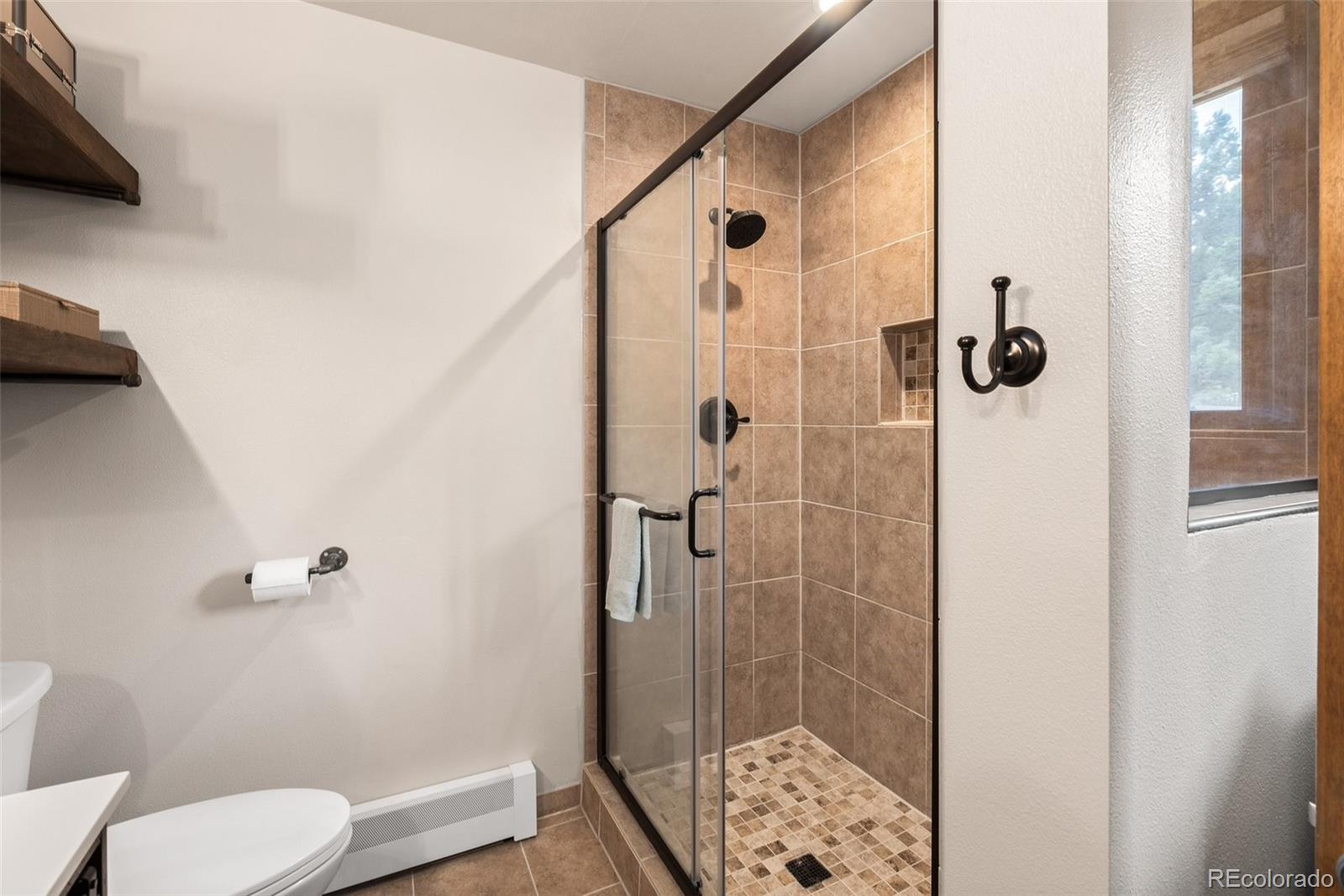 30540 Rand Road Conifer, CO 80433 - Photo 14 of 37 a bathroom with a shower and toilet