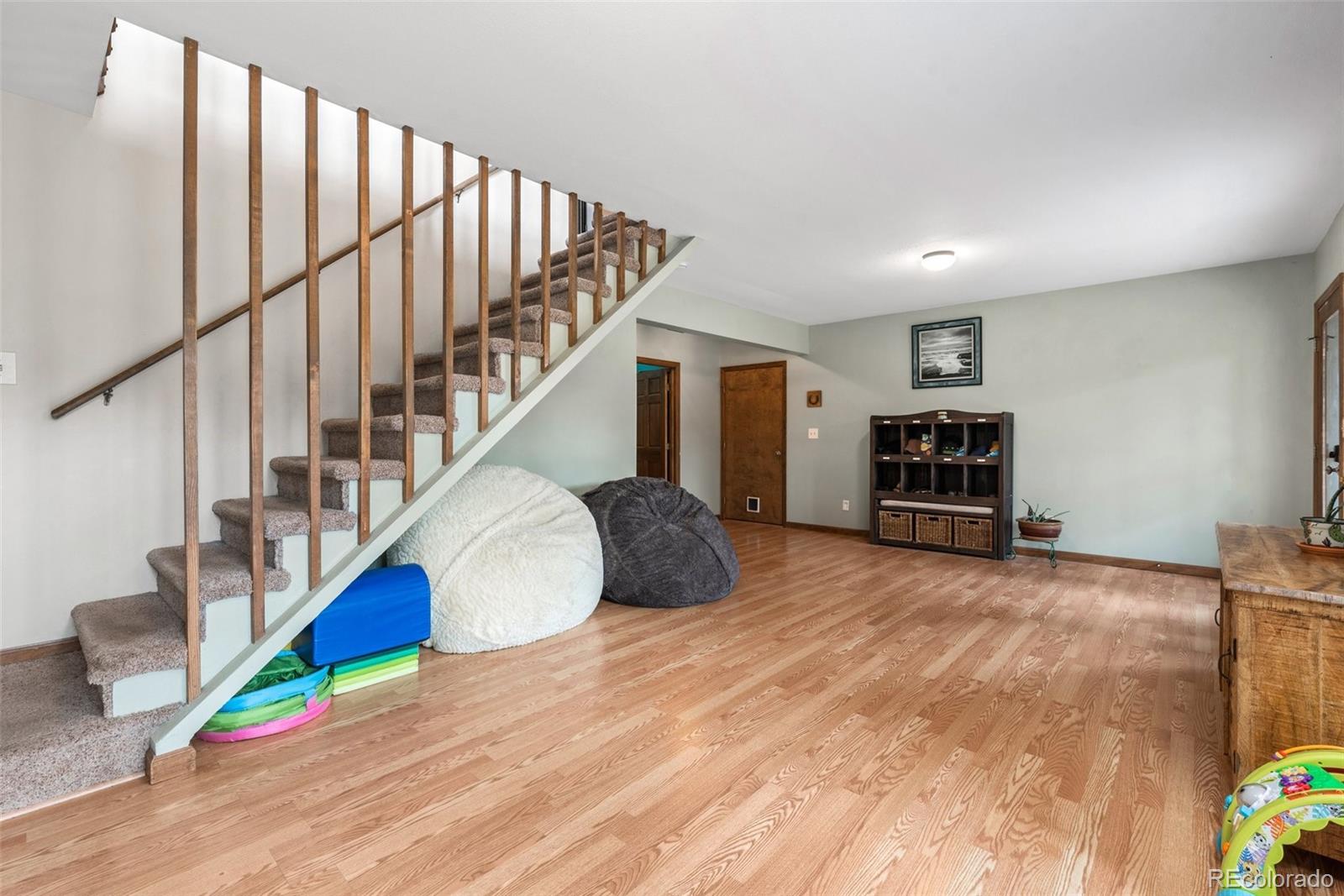 30540 Rand Road Conifer, CO 80433 - Photo 20 of 37 a room with stairs and a wooden floor