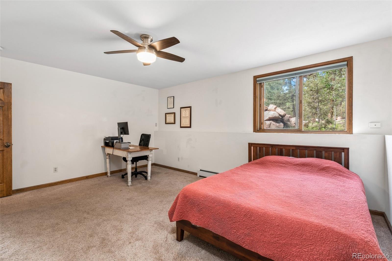 30540 Rand Road Conifer, CO 80433 - Photo 22 of 37 a bedroom with a bed and a window