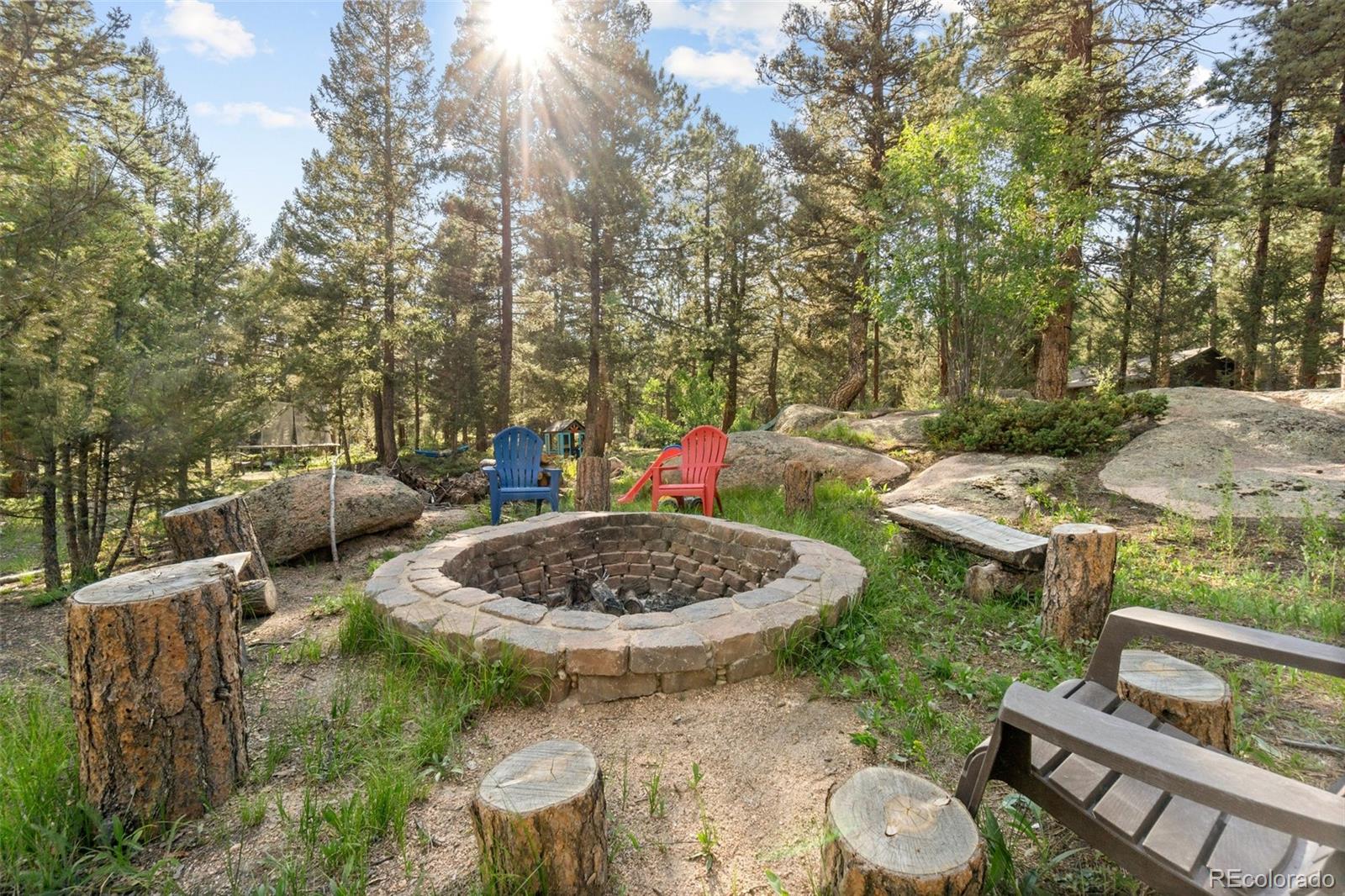30540 Rand Road Conifer, CO 80433 - Photo 32 of 37 a backyard of a house with fire pit and outdoor seating
