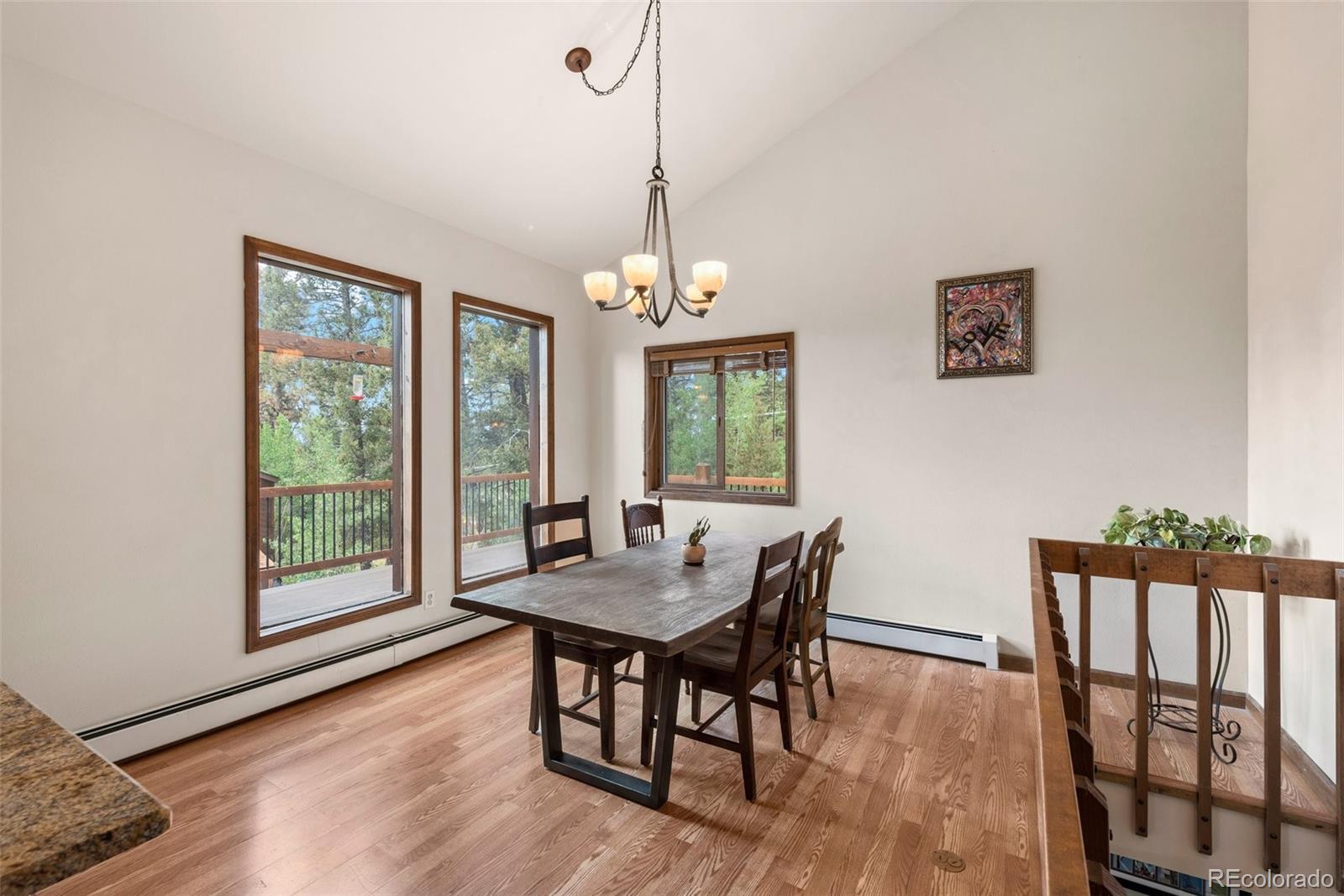 30540 Rand Road Conifer, CO 80433 - Photo 4 of 37 a dining room with furniture window wooden floor