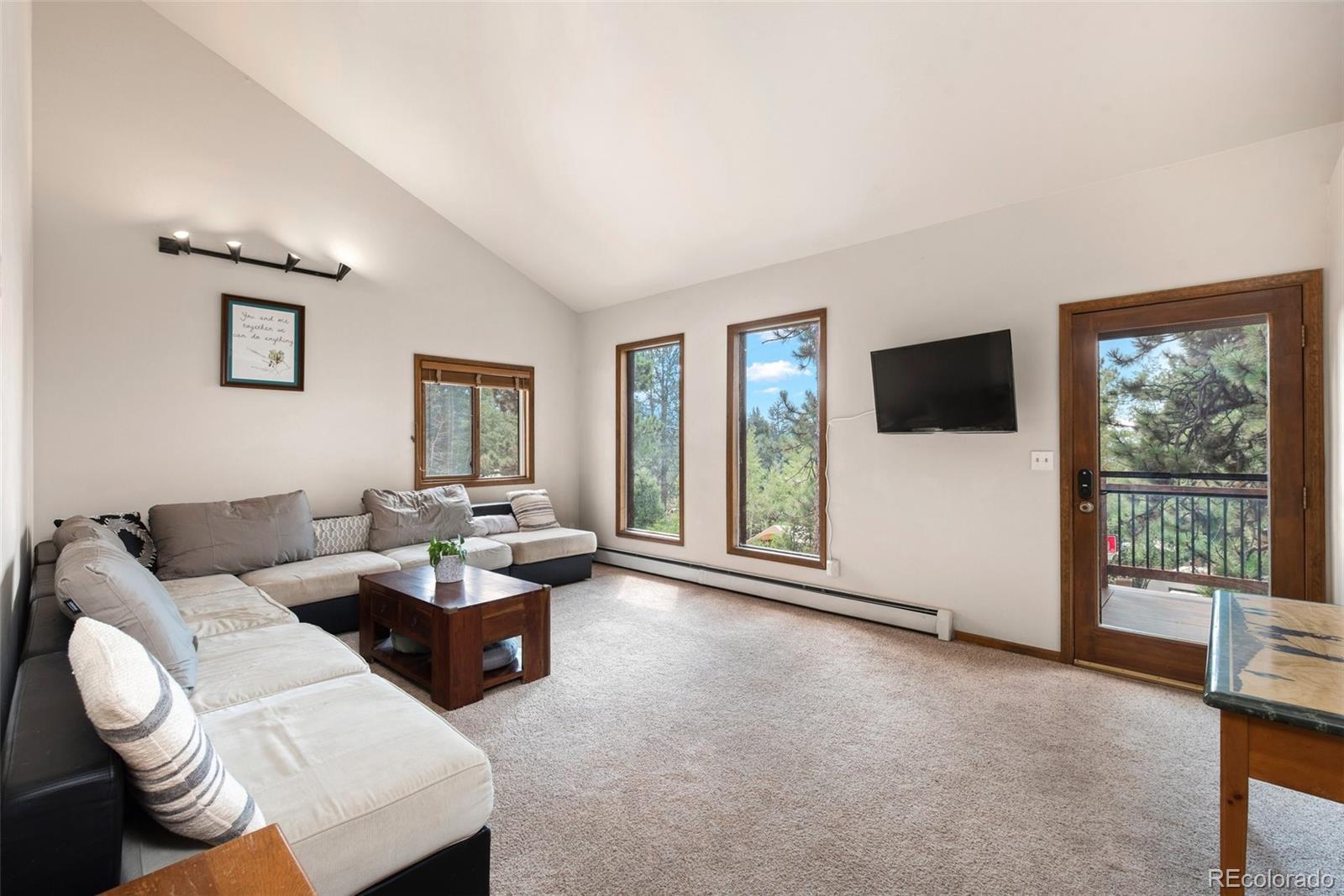 30540 Rand Road Conifer, CO 80433 - Photo 8 of 37 a living room with furniture and a flat screen tv