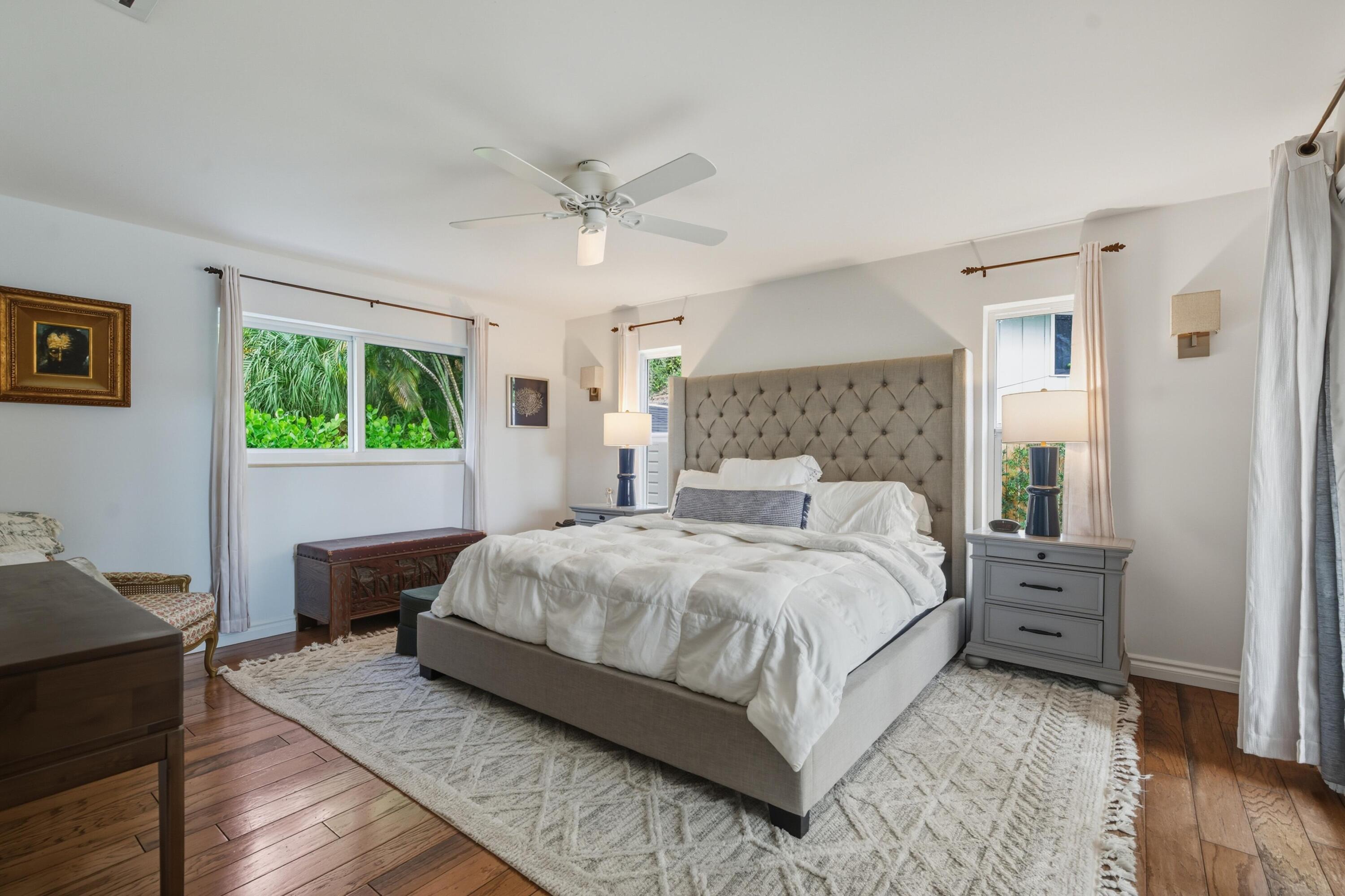 2642 Northeast 26th Terrace Lighthouse Point, FL 33064 - Photo 15 of 53 a bedroom with a large bed wooden floor and window